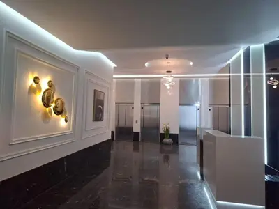 a hallway of a building with a lobby with gold fixtures at New 8th floor Terrace 5 min from train stations in Casablanca