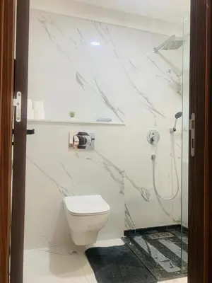 a white bathroom with a toilet and a shower at New 8th floor Terrace 5 min from train stations in Casablanca