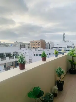 a balcony with potted plants on top of a building at New 8th floor Terrace 5 min from train stations in Casablanca
