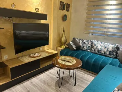 a living room with a couch and a flat screen tv at Apartamento Temara Morroco in Temara