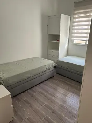 a small bedroom with a bed and a closet at Apartamento Temara Morroco in Temara