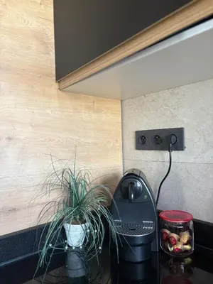 a kitchen counter with a coffee maker and a plant at Twin Center View Apt in Maarif in Maarif