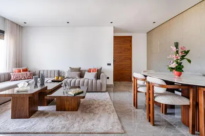 a living room with a couch and a table at Prestigieux appartement 3 chambre plein cœur CFC in Casablanca
