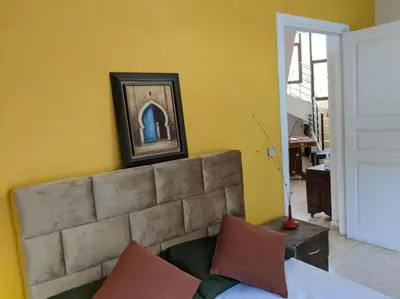 a living room with a couch and a picture on the wall at Cosy and Spacious 4BR villa 5 min to Hay Riad in Temara