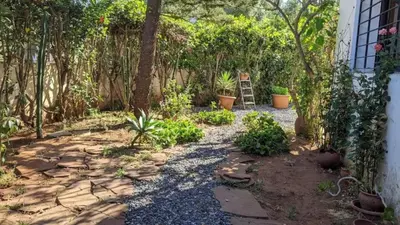 a garden with a ladder next to a house at Cosy and Spacious 4BR villa 5 min to Hay Riad in Temara