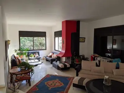 a large living room with couches and a red wall at Cosy and Spacious 4BR villa 5 min to Hay Riad in Temara