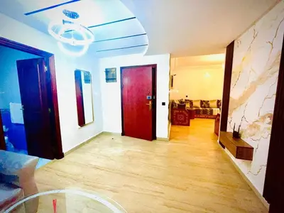 a living room with a red door and a living room at Modern Central Apartment in Casablanca in Casablanca