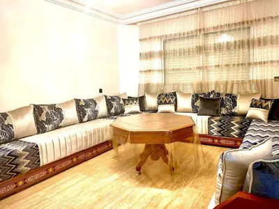 a living room with a couch and a coffee table at Modern Central Apartment in Casablanca in Casablanca