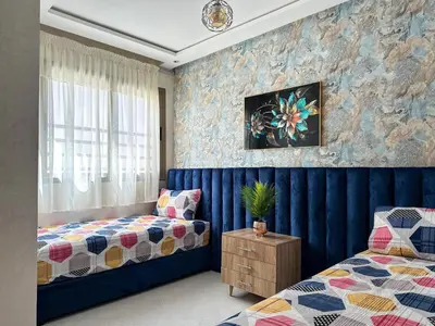 a bedroom with a bed and a window at Appartement chic Dahomey plage - Rabat & Bouznika, mer et culture in Bouznika