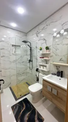 a bathroom with a shower and a toilet and a sink at Appartement chic Dahomey plage - Rabat & Bouznika, mer et culture in Bouznika