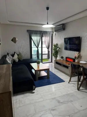 a living room with a couch and a table at Studio Stadium morocco for family in Mohammedia