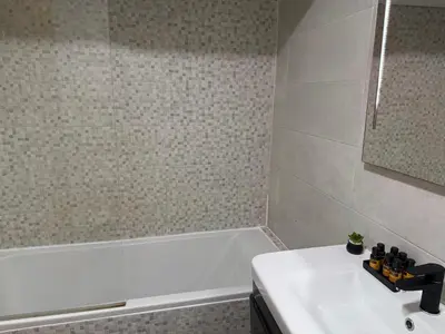 a bathroom with a white tub and a sink at Studio Stadium morocco for family in Mohammedia