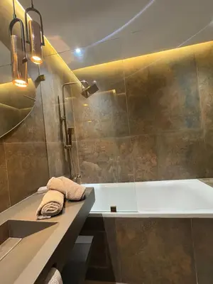 a bathroom with a tub and a sink and a shower at Appartement haut standing Casablanca in Casablanca