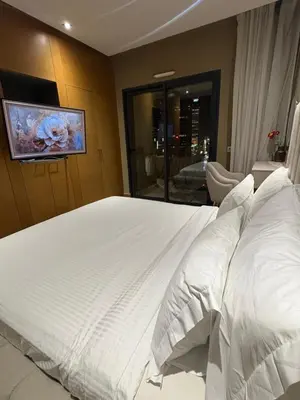 a bedroom with a large white bed with white pillows at Appartement haut standing Casablanca in Casablanca