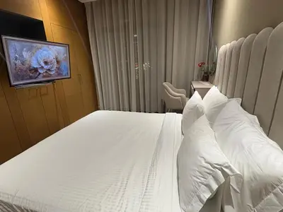 a bedroom with a bed with white sheets and pillows at Appartement haut standing Casablanca in Casablanca