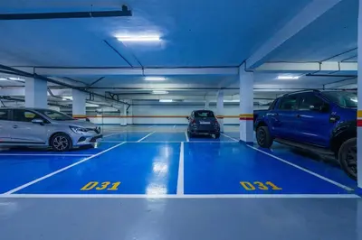 a parking garage with three cars parked in it at Luxueux appartement 3 chambre en plein cœur CFC NEXT HOUSE 3 in Casablanca