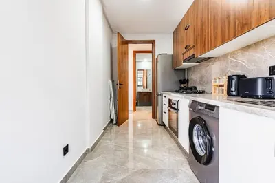 a kitchen with a washer and dryer at Luxueux appartement 3 chambre en plein cœur CFC NEXT HOUSE 3 in Casablanca