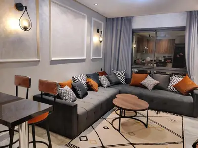 a living room with a couch with pillows on it at Studio Maarif 5 minutes from Mohamed V studium in Casablanca