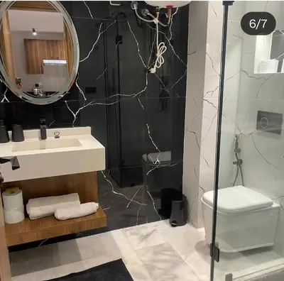 a bathroom with a sink and a toilet and a mirror at Studio Maarif 5 minutes from Mohamed V studium in Casablanca