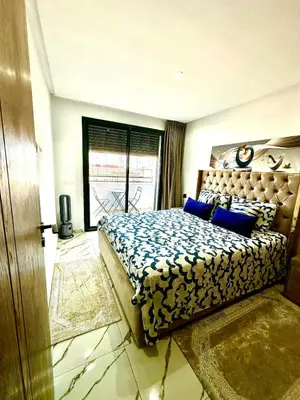 a bedroom with a large bed with blue pillows at Pause cosy moderne in Casablanca