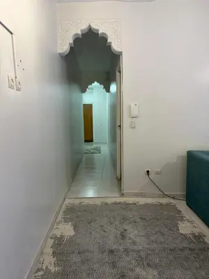 a hallway with a door and a rug on a wall at Résidence Haja in Casablanca