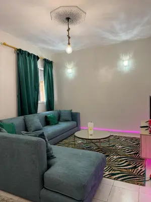 a living room with a couch and a table at Résidence Haja in Casablanca