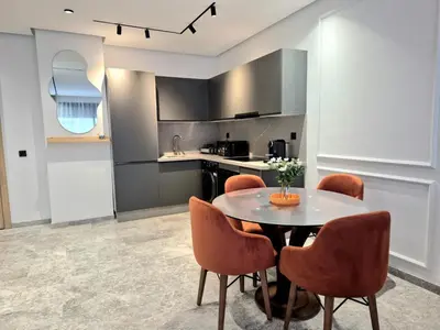 a kitchen and dining room with a table and chairs at VIVASTAY Casablanca - Metropole Bd Abdelmoumen in Casablanca