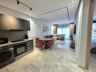 a kitchen and living room with a couch and a table at VIVASTAY Casablanca - Metropole Bd Abdelmoumen in Casablanca