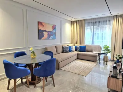 a living room with a couch and a table and chairs at VIVASTAY Casablanca - Metropole Bd Abdelmoumen in Casablanca