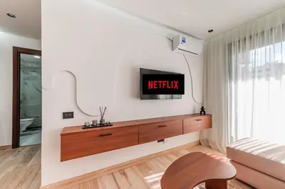 a living room with a tv on a wall at Studio Signature - Parking privé & neuf in Casablanca