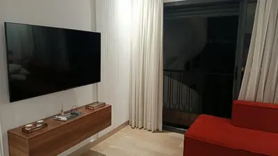 a living room with a flat screen tv on a wall at Studio Casablanca Les Princesses amirat in Maarif