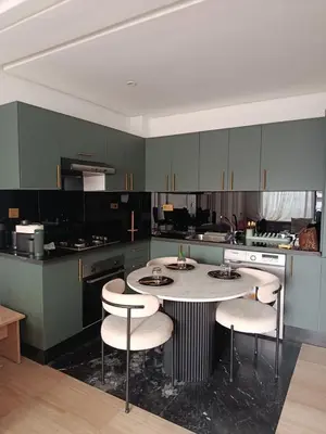 a kitchen with a table and chairs in it at Studio Casablanca Les Princesses amirat in Maarif