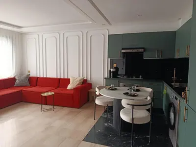 a living room with a red couch and a table at Studio Casablanca Les Princesses amirat in Maarif