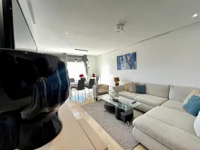 a living room with a couch and a table at Luxurious 1BR Orangeraie - Terrace & Pool in Oulad Akkou