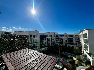 a view of a building from a balcony with a table at Luxurious 1BR Orangeraie - Terrace & Pool in Oulad Akkou