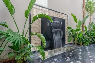 a black fire place in a room with plants at Séjour élégant avec terrasse et vue sur la ville in Casablanca