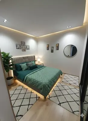 a bedroom with a green bed and a mirror at Séjour élégant avec terrasse et vue sur la ville in Casablanca