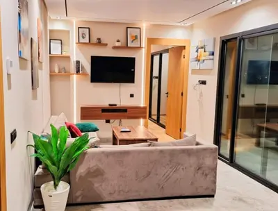 a living room with a couch and a tv at Séjour élégant avec terrasse et vue sur la ville in Casablanca