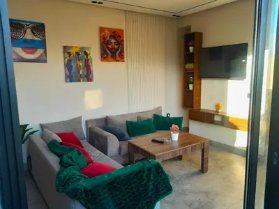 a living room with a couch and a table at Séjour élégant avec terrasse et vue sur la ville in Casablanca