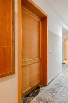a wooden door in a room with a tile floor at Appartement spacieux Océan Rabat in Rabat