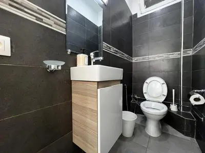 a bathroom with a sink and a toilet at Cozy & Stylish 2BR - Near Arribat Center Mall in Rabat
