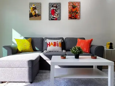 a living room with a couch and a table at Cozy & Stylish 2BR - Near Arribat Center Mall in Rabat