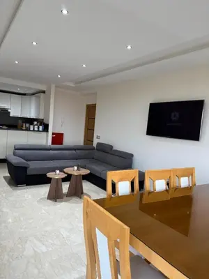 a living room with a couch and a table at Evasion apartment with beach and pool views in Bouznika