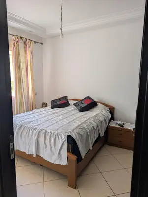 a bedroom with a bed with two pillows on it at Maison Lalla najat in Sidi Rahal