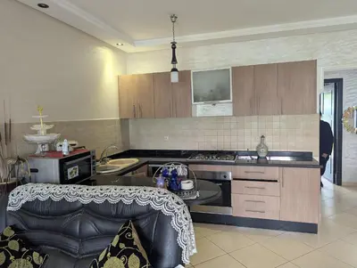 a kitchen with a stove and a counter top at Maison Lalla najat in Sidi Rahal