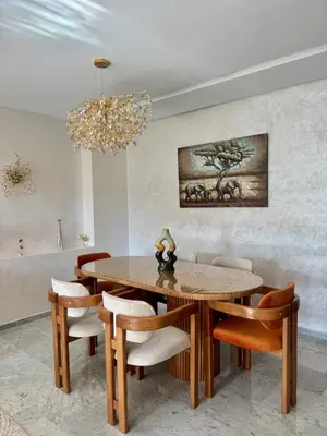 a dining room with a table and chairs and a chandelier at Anfa Ivory Hassan II in Casablanca