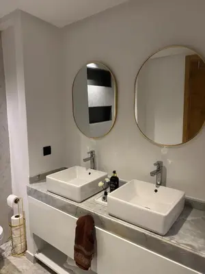 a bathroom with two sinks and a mirror at Anfa Ivory Hassan II in Casablanca