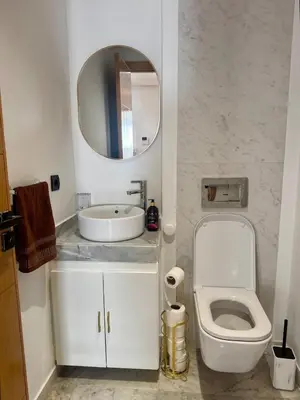 a bathroom with a sink and a toilet and a mirror at Anfa Ivory Hassan II in Casablanca