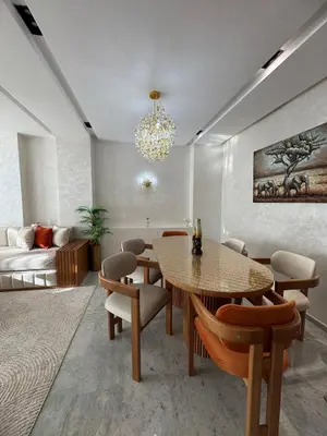 a living room with a table and chairs and a couch at Anfa Ivory Hassan II in Casablanca