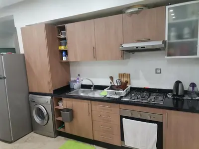 a kitchen with a sink and a stove top oven at Central Park in Mohammedia
